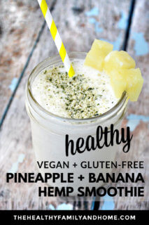 A glass full of Pineapple and Banana Hemp Smoothie with pineapple chunk garnish on a weathered wooden surface with text overlay