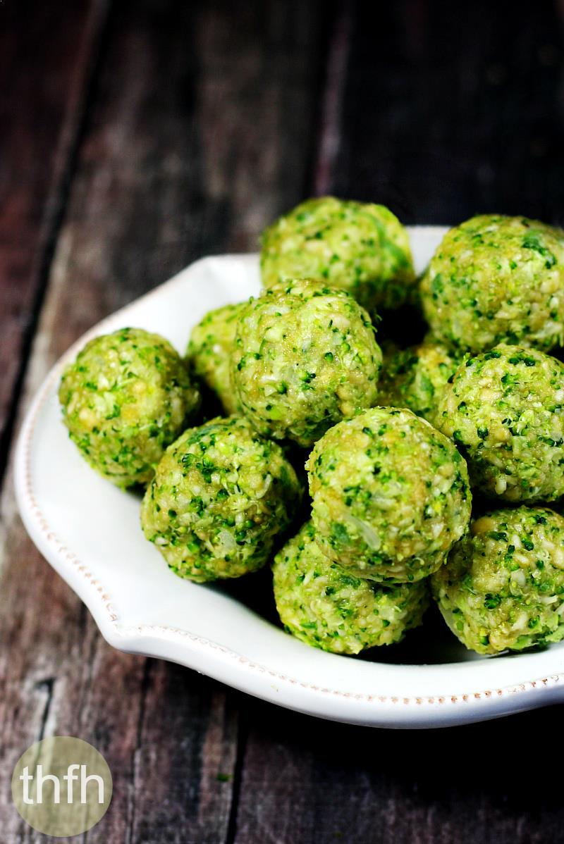 Vertical view of white bowl full of Gluten-Free Vegan Raw No-Cook Broccoli Balls on a wooden surface