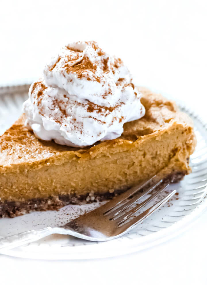 Close-up image of a slice of Gluten-Free Vegan No-Bake Pumpkin Pie with a silver fork next to it