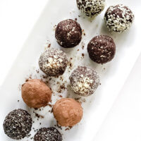 Overhead view of Gluten-Free Vegan Healthy No-Bake Crunchy Protein Energy Balls on a white platter on a white surface