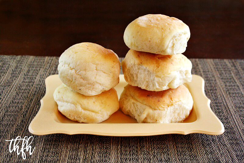 Horizontal view of a stack of The BEST Homemade Vegan Egg-Free "Hamburger"Buns on a yellow plate