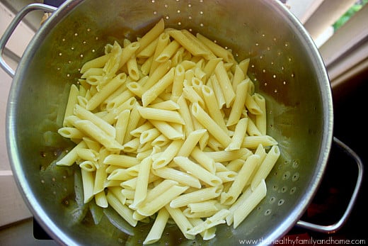 A stainless steel strainer showing cooked and drained pasta ready to use to make baked penne pasta recipe
