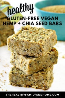 Vertical image of a stack of Gluten-Free Vegan No-Bake Hemp and Chia Seed Bars on a white surface with a blue bowl and extra bars in the background with text overlay
