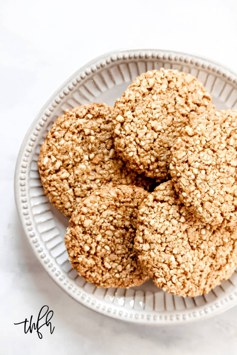 Overhead view of a plate full of Gluten-Free Vegan Flourless Coconut Cashew Cookies on a white background