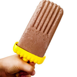 A small hand holding up a chocolate fudgesicle on a solid white background