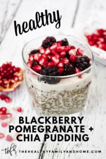 Vertical image of a square dessert glass filled with chia pudding topped with blackberries and pomegranates on a weathered wooden surface with text overlay