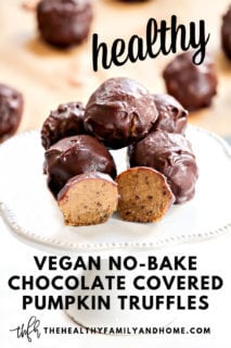 Close up image of a stack of The BEST Vegan No-Bake Chocolate Covered Pumpkin Truffles on a small cake platter with text overlay