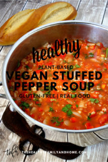 Overhead vertical image of a pot of The BEST Gluten-Free Vegan Stuffed Pepper Soup on a wooden surface with text overlay