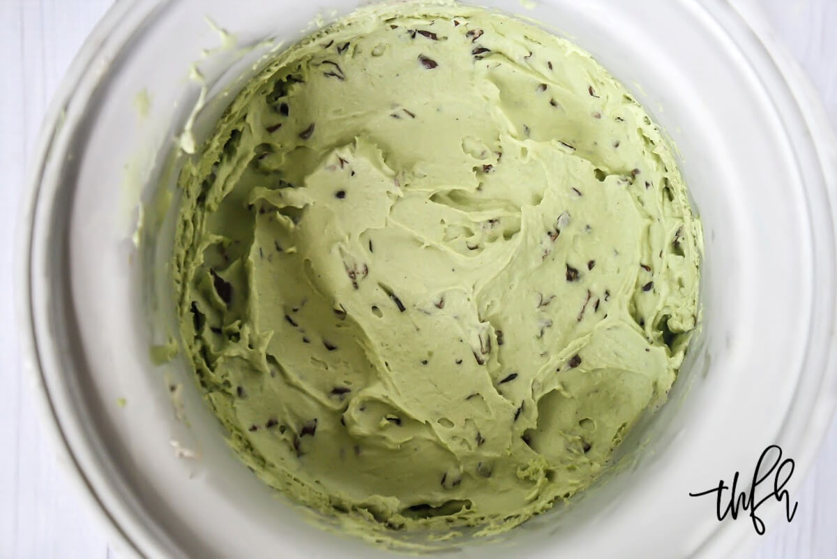 Overhead image of light green ice cream inside an ice cream maker