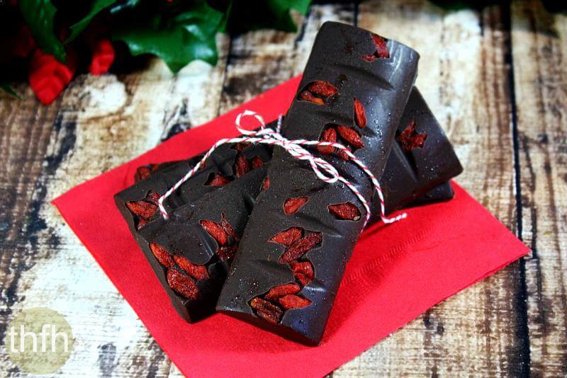 Clean Eating Gluten-Free Vegan No-Cook Chocolate Peppermint Candy Bars on a wooden background surrounded by Christmas follage
