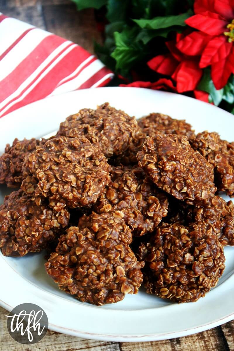 Vertical view of The ORIGINAL Healthy Gluten-Free Vegan No-Bake Chocolate Peanut Butter Oat Cookies on a white plate on a wooden background