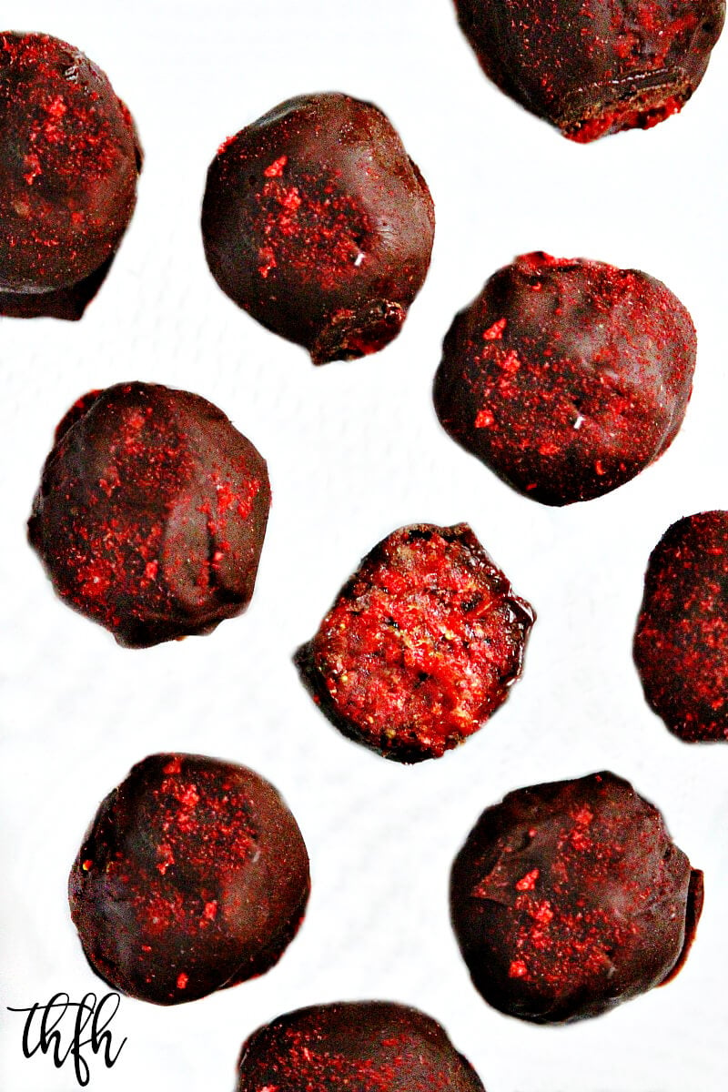 Overhead view of Clean Eating Gluten-Free Vegan No-Cook Chocolate Covered Strawberry Truffles on a white background