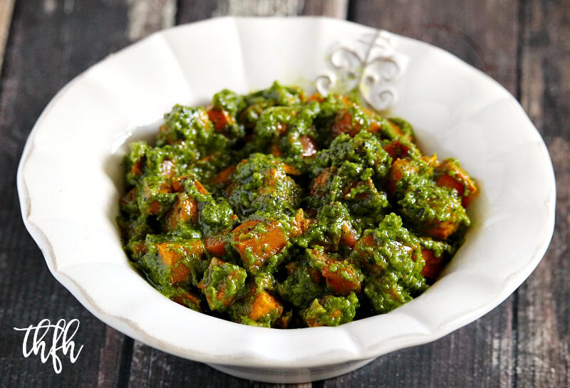 Lectin-Free and Gluten-Free Vegan Cilantro Pesto Sweet Potato Salad in a white bowl on a wooden surface