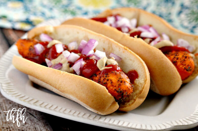 Two Gluten-Free Vegan Healthy Carrot "Hot Dogs" on a cream plate on a wooden background