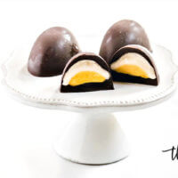 Horizontal image of Gluten-Free Vegan Healthy "Cadbury Creme Eggs" on a dessert platter on a white background