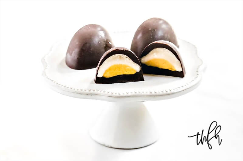 Horizontal image of Gluten-Free Vegan Healthy "Cadbury Creme Eggs" on a dessert platter on a white background
