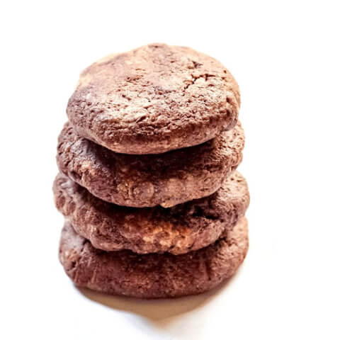 Stack of four Gluten-Free Vegan Flourless Chocolate Fudge Mint Cookies on a white background