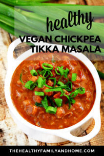 A white soup bowl filled with Gluten-Free Vegan Chickpea Tikka Masala on a weathered wooden surface with text overlay